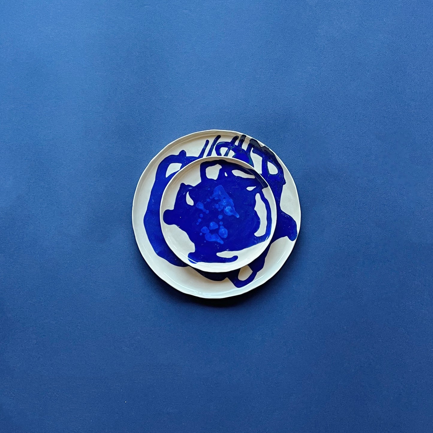 handmade ceramic esquitx dessert plate on top of esquitx dinner plate