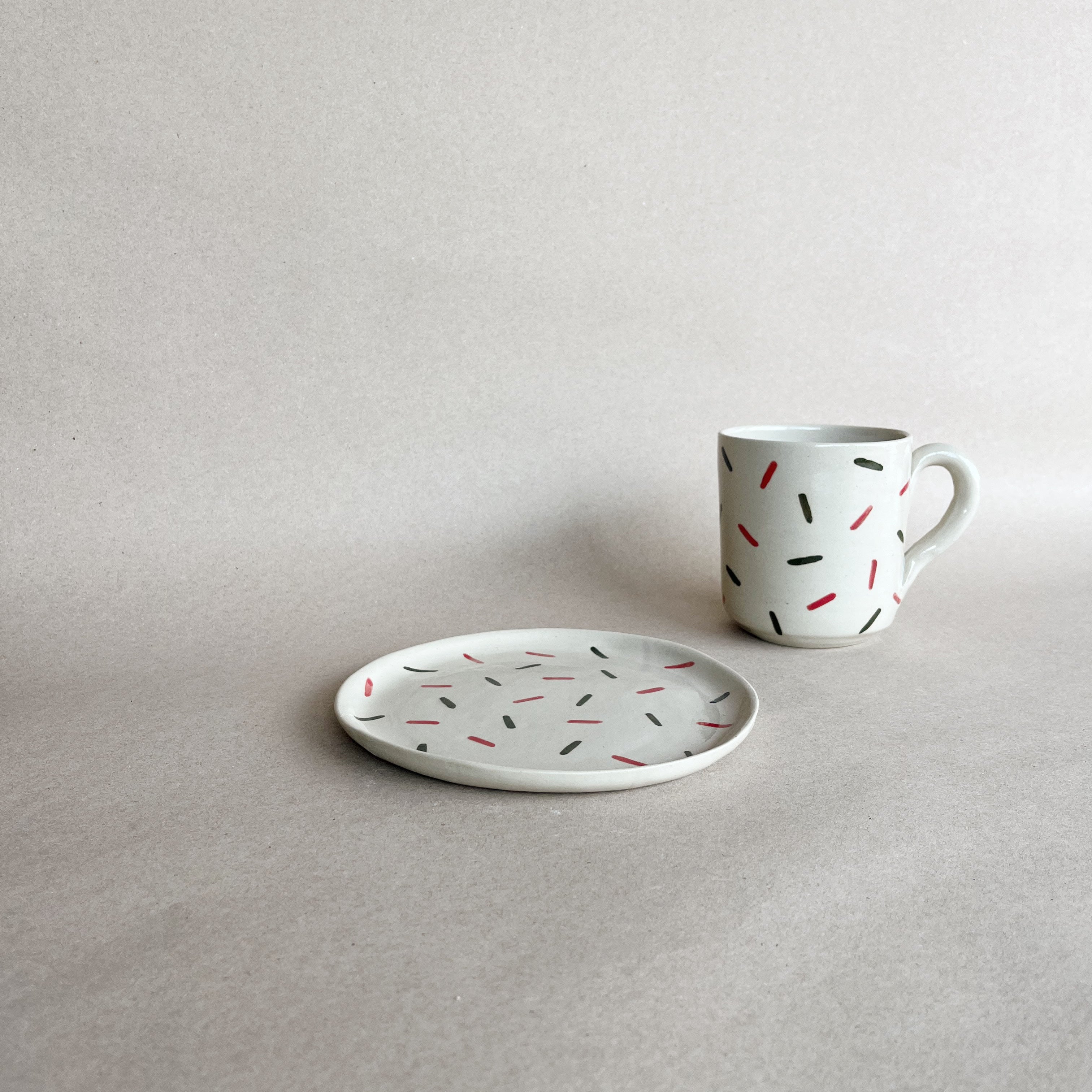 handmade ceramic siurell mug on the side of siurell dessert plate