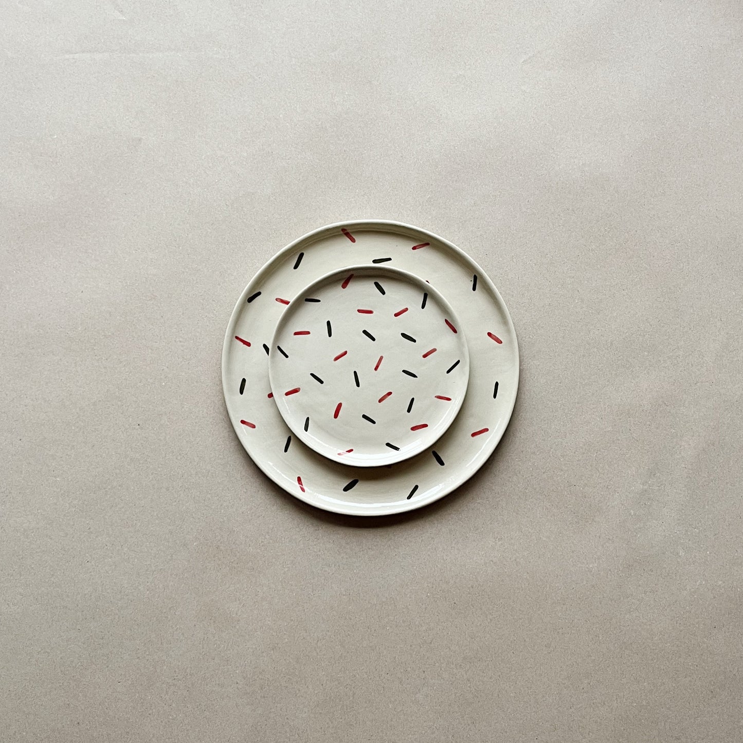 handmade ceramic siurell dessert plate on top of siurell dinner plate