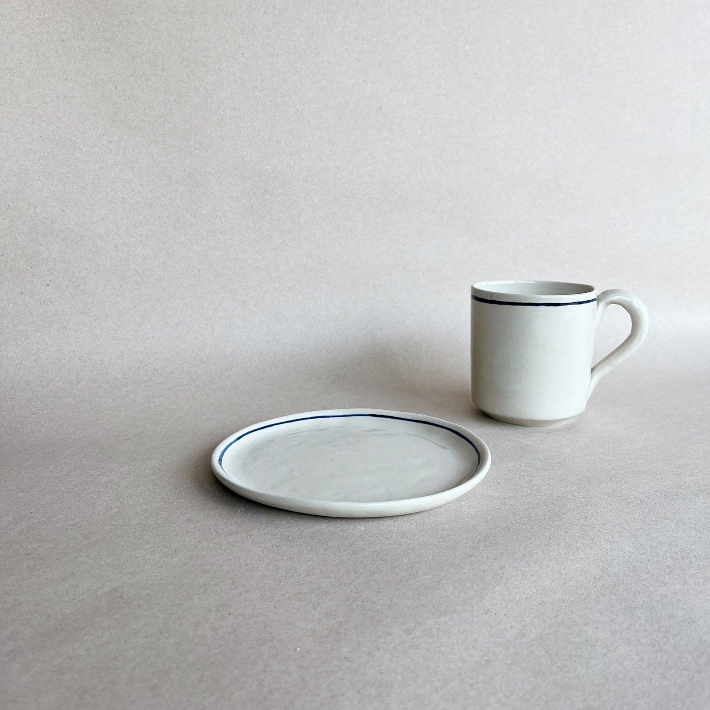 handmade ceramic viu mug on the side of viu dessert plate