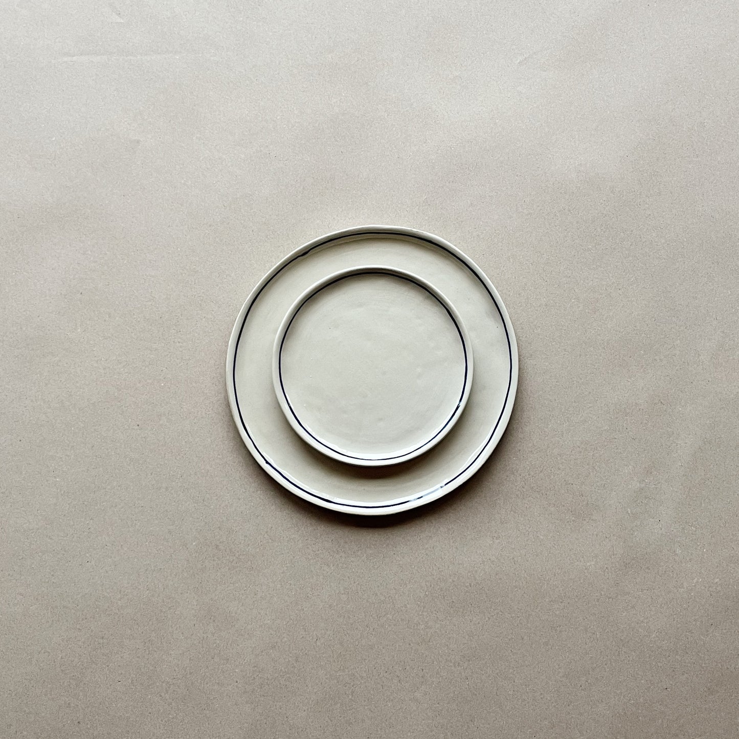 handmade ceramic viu dessert plate on top of viu dinner plate