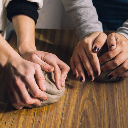Close-up of hands shaping clay in our one-day ceramic workshop.